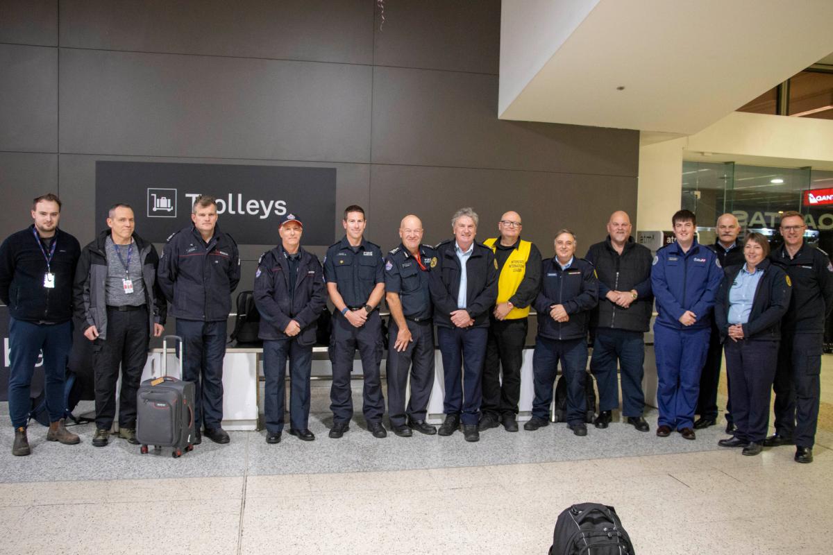 Group of people in uniform standing in a line looking at the camera 